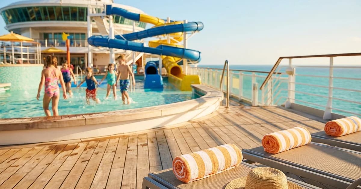 Cruise ship pool deck with kids of multiple ages playing on water slides
