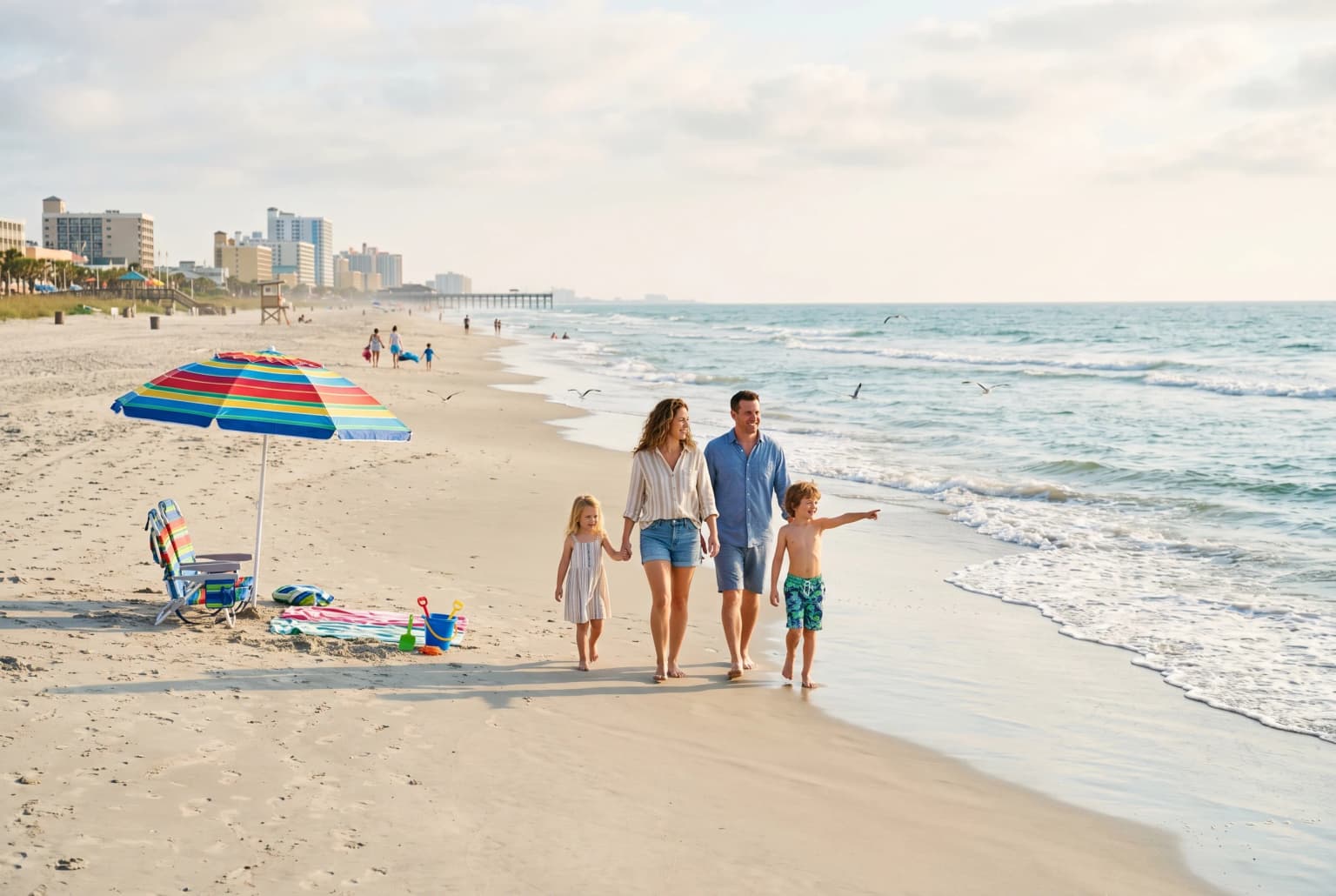 Family walking on Myrtle Beach shoreline in morning light