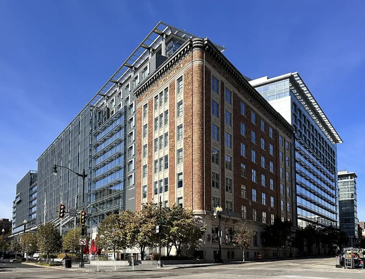 The Marriott Marquis Washington DC, a historic brick facade joined to modern glass wings, on a sunny downtown corner.